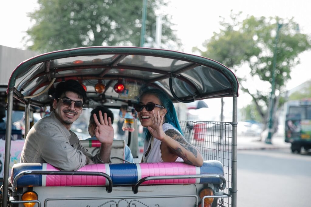 A Couple Riding a Motorized Taxi