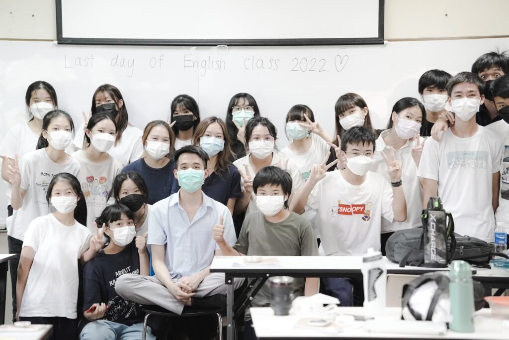 a group of people wearing face masks posing for a picture